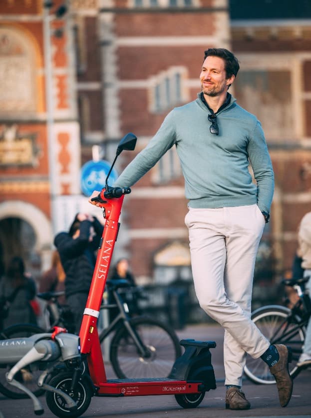 Een man met een goedgekeurde e-step op het Museumplein in Amsterdam.